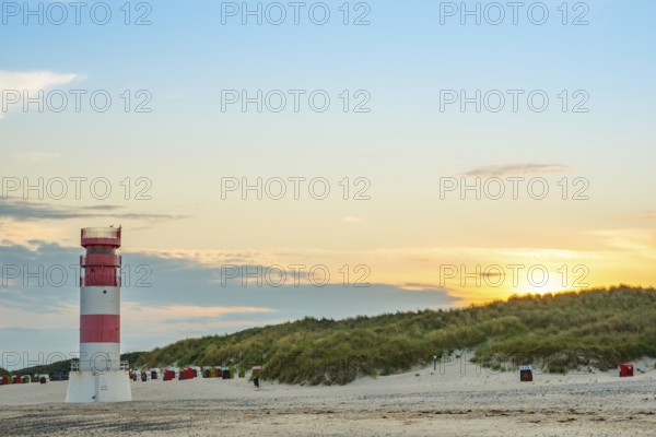 Red, white lighthouse Heligoland dune (Oberfeuer), striped, south beach, beach chairs, dunes, common beach oats (Ammophila arenaria (L.) Link, syn.: Calamagrostis arenaria (L.) Roth), also common beach oats, sand straw, deserted, no one, without people, warm, gentle sunlight at sunset, evening mood and relaxed atmosphere, atmospheric, colorful, quiet, vacation, summer, evening sun, dune island, Heligoland, Pinneberg district, Schleswig-Holstein, North Sea, Germany