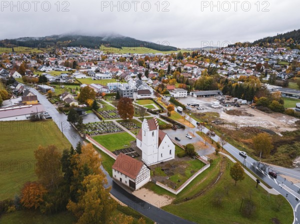 Small town with a central church, nestled in an autumn-colored area, Wehingen, Tuttlingen district, Germany