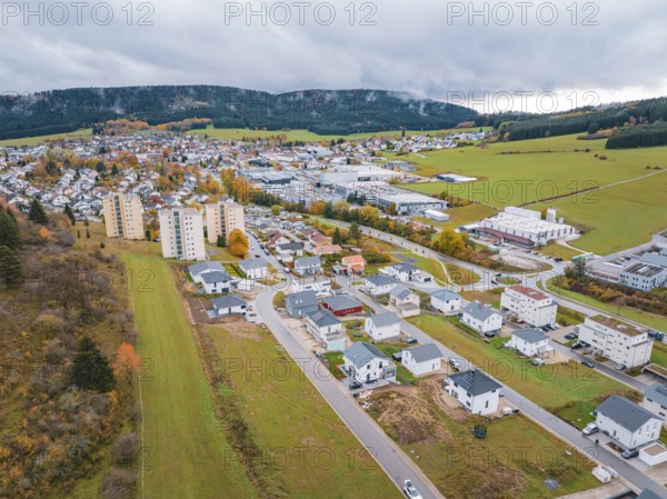 Aerial view of a city with autumn colors and clouds in the sky, Wehingen, Tuttlingen district, Germany