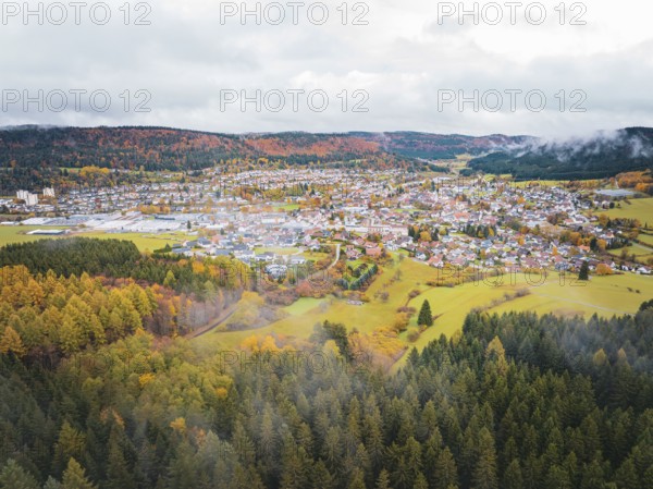 Village surrounded by autumn forests. Foggy hills and vivid colors, Wehingen, Tuttlingen district, Germany