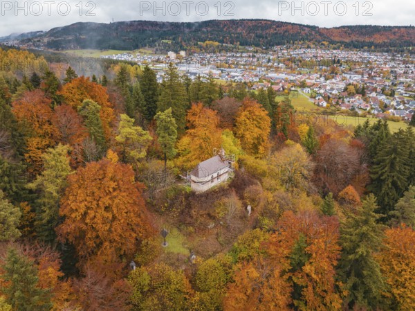 Small platform above a colorful autumn forest, the village in the background, Wehingen, Tuttlingen district, Germany