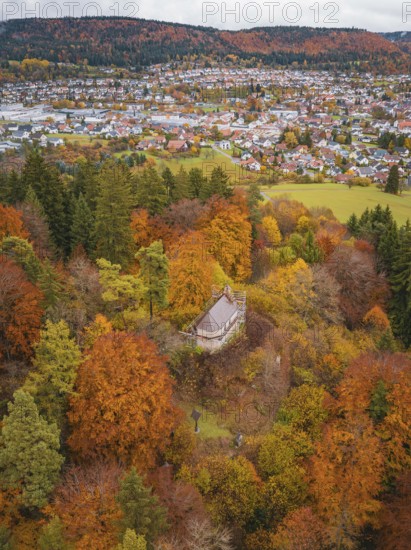 Viewing platform in an autumn forest with a view of a village below, Wehingen, Tuttlingen district, Germany