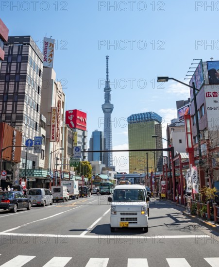 Street with typical Japanese houses, Sumida City skyline in the back, Sumida City Office, Tokyo Skytree, and Asahi Headquarters, Asakusa, Tokyo, Japan
