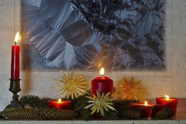 Christmassy decorated iced window, candle light, straw stars, Germany