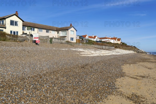 For Sale estate agent signs outside houses at risk of coastal erosion, Thorpeness, Suffolk, North Sea coast, England, UK October 2025