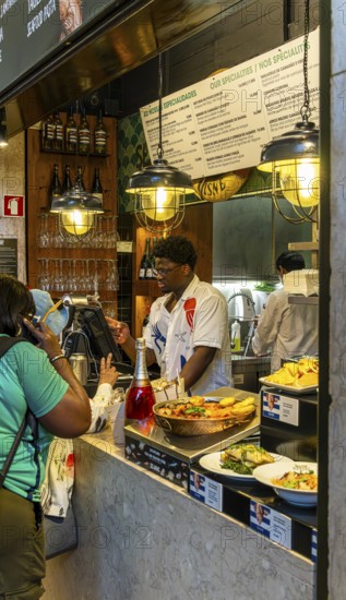 The Mercadeo da Ribeira, also known as TimeOut Market, is the best address for Portuguese specialties and international cuisine. Historic market hall at Cais do Sodré station, Lisbon, Portugal