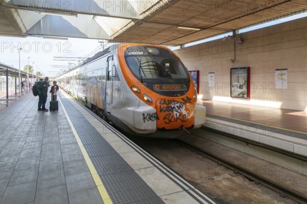 Renfe Civia commuter train at platform of Airport railway station, Rodalia de Barcelona suburban rail network, Barcelona, Catalonia, Spain
