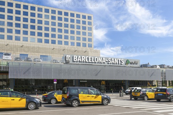 Taxis in street outside Barcelona-Sants railway station building in city centre, Barcelona, Catalonia, Spain