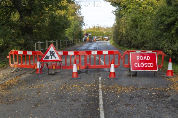 Road and rail level crossing closed, Network Rail railway line upgrade maintenance, Melton, Suffolk, England, UK autumn 2025