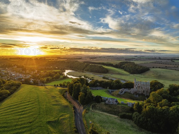 Sunset over Norham Castle and River Tweed from a drone, Norham, Northumberland, England, United Kingdom