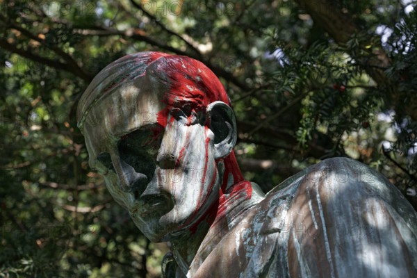 Colonial War Memorial, head sprayed with red paint, in commemoration of the Herero and Nama genocide in German Southwest Africa, Düsseldorf, North Rhine-Westphalia, Germany
