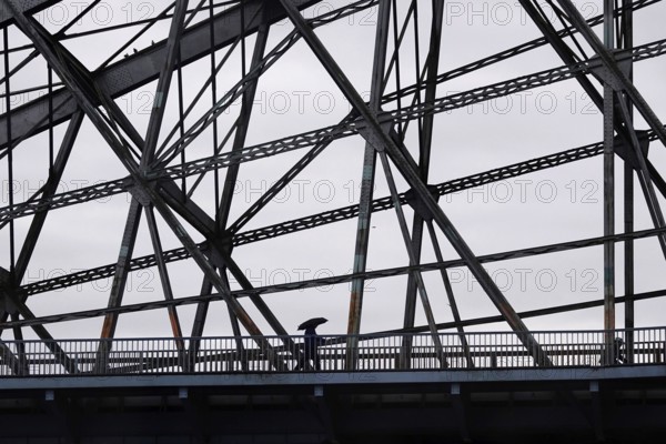 Passers-by with umbrella on a bridge, autumn, rainy weather, Germany