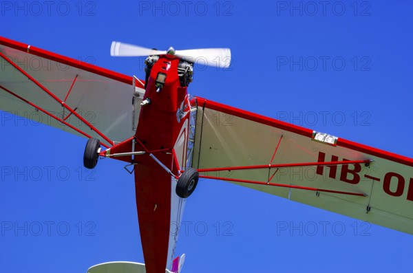 A Piper J-3C/L4 Cub light aircraft, HB-OBF registration, during a flight demonstration as part of an air show on Rossfeld in Metzingen-Glems, Baden-Württemberg, Germany, for editorial use only