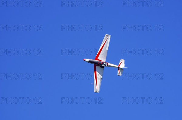 A single-engine aerobatic aircraft during a flight demonstration at the Rossfeld Luftsportverein in Rossfeld in Metzingen-Glems, Baden-Württemberg, Germany, for editorial use only