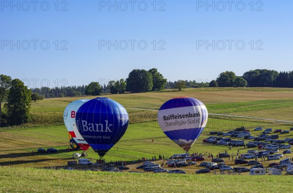 Hot air balloons are being prepared for takeoff as part of an air show at the Fliegerbergfest of the Rossfeld Luftsportverein in Metzingen-Glems, Baden-Württemberg, Germany, for editorial use only
