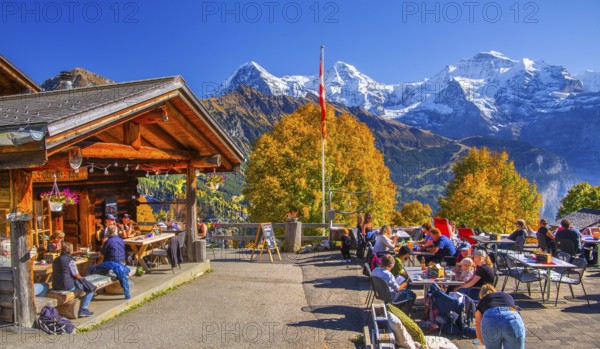Sun terrace of the mountain inn in the hamlet of Sulwald with Eiger 3967m, Mönch 4110m and Jungfrau 4158m in autumn, Isenfluh, Lauterbrunnental, Bernese Oberland, Canton of Bern, Switzerland