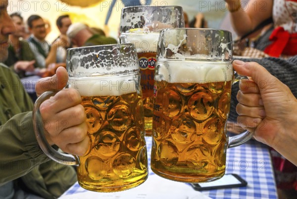 Guests toast with beer mugs, beer mug, Hacker-Pschorr party tent, Bavarian sky, Oktoberfest, Munich, Bavaria, Germany