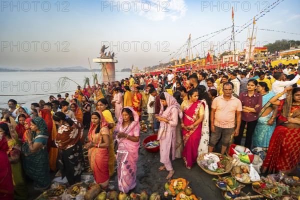 Hindu devotees gather on the banks of the Brahmaputra River to offer prayers to the Sun God on the occasion of Chhath Puja, in Guwahati, India on 27 October 2025