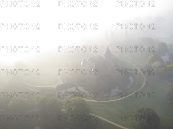 Aerial view of Linn Krefeld Castle in fog, North Rhine-Westphalia, Germany