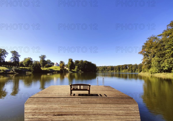 Footbridge with bench to Huwenowsee at Meseberg Castle Park, guest house and conference venue of the Federal Government, Gransee, Brandenburg, Germany