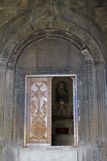 Wooden door with cross in artistically engraved stone archway, Noravank Monastery, Surb Karapet Anabaptist Church, Noravank, Vayots Dzor Province, Wajoz Dzor, Armenia, Caucasus
