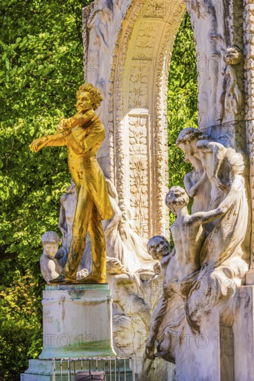 The gilded bronze statue of Johann Strauss, the Waltz King, memorial in the municipal park, Vienna, Austria
