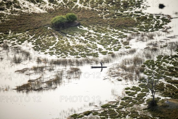 Marshland, marshland with canals, Kavango fishermen with his Mokoro, aerial view, Okavango Delta, Botswana