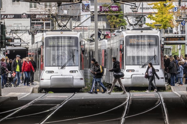 Pedestrians cross the tram tracks, at Düsseldorf-Bilk station, junction of S-Bahn, subway, tram, local bus transport, North Rhine-Westphalia