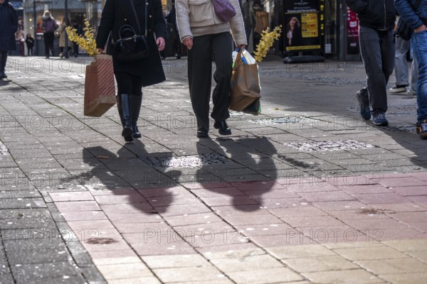Shadows of passers-by shopping in the city center, Essen, North Rhine-Westphalia