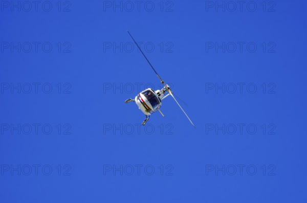 An Aerospatiale AS-350 BA Ecureuil helicopter, registration D-HAAN, from Meravo Air Company during a flight demonstration as part of an air show on Rossfeld in Metzingen-Glems, Baden-Württemberg, Germany, for editorial use only