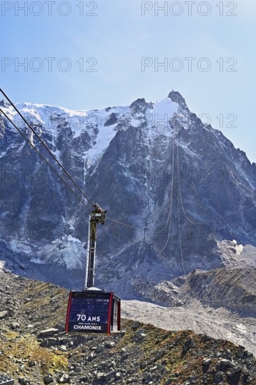 View of the arriving cable car from the Plan de l'Aiguille middle station, in the back the mountain station of the Aiguille du Midi, Chamonix-Mont-Blanc, Haute-Savoie, France