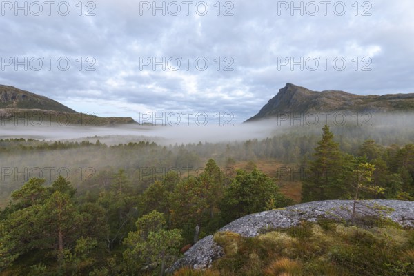 Magical morning fog on Steigtindvatnet in front of the majestic Litltind in Norway near Bodø