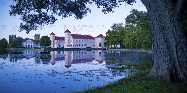 Rheinsberg Castle, lakeside with Lake Grienerick at night, prime example of Friederician Rococo, Brandenburg, Germany