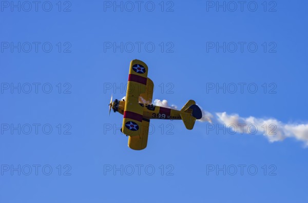 A Boeing PT-17 Stearman biplane, also Boeing Stearman Model 75, with the inscription 399 USNAVY N67193 during a flight demonstration as part of an air show on Rossfeld in Metzingen-Glems, Baden-Württemberg, Germany, for editorial use only
