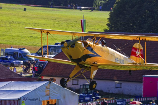A biplane Bücker Bü 131 Jungmann with the registration HB-UUD during a flight demonstration as part of an air show on Rossfeld in Metzingen-Glems, Baden-Württemberg, Germany, for editorial use only