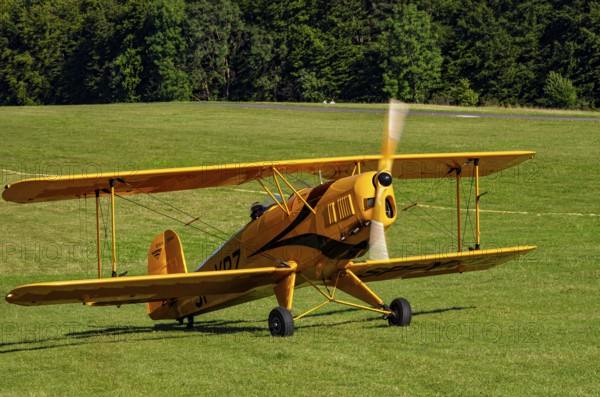 A biplane Bücker Bü 131 Jungmann with registration SP-YPZ during a flight demonstration as part of an air show on Rossfeld in Metzingen-Glems, Baden-Württemberg, Germany, for editorial use only
