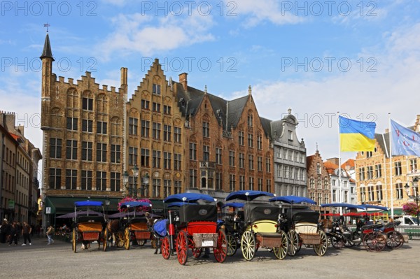 Historic houses on the market square in the old town of Bruges with horse-drawn carriages, Grote Markt, UNESCO World Heritage Site, Flanders, Belgium
