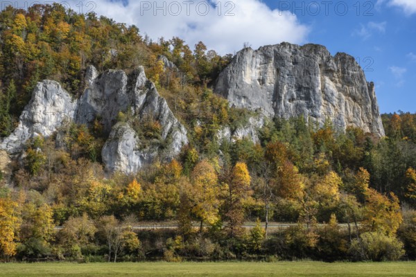 Distinctive Jurassic limestone cliffs in the upper Danube Valley, surrounded by autumn vegetation, on the right the raven rocks, Sigmaringen district, Baden-Württemberg, Germany
