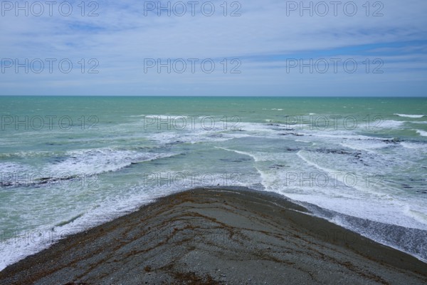 Sea with foaming waves and cloudy sky, Tuhawaiki Point Lighthouse or Jack's Point Lighthouse, Scarborough, Timaru, South Island, New Zealand