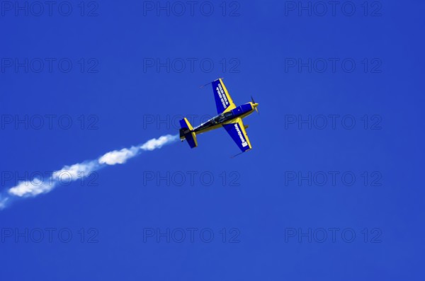 An Extra EA-300 from Extra Flugzeugproduktions- und Vertriebs GmbH with registration D-EXBH during a flight demonstration as part of an air show on Rossfeld in Metzingen-Glems, Baden-Württemberg, Germany, for editorial use only