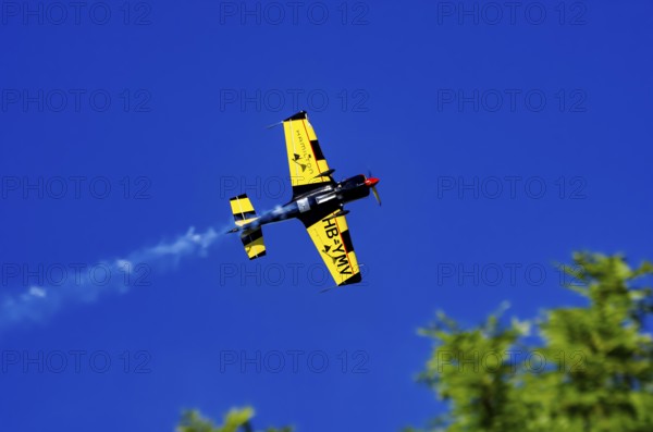A Votec 351 sport aircraft from the Swiss MSW Aviation AG with registration HB-YMV during a flight demonstration as part of an air show on Rossfeld in Metzingen-Glems, Baden-Württemberg, Germany, for editorial use only