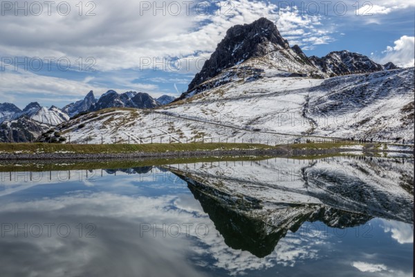 Kanzelwand is reflected in the reservoir, Kanzelwand snow-making pond, mountains of the Allgäu Alps behind, Vorarlberg, Austria