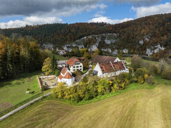 Aerial view of Käppeler Manor with St. George's Basilica near Thiergarten in the Upper Danube Valley, surrounded by autumn vegetation, Sigmaringen district, Baden-Württemberg, Germany