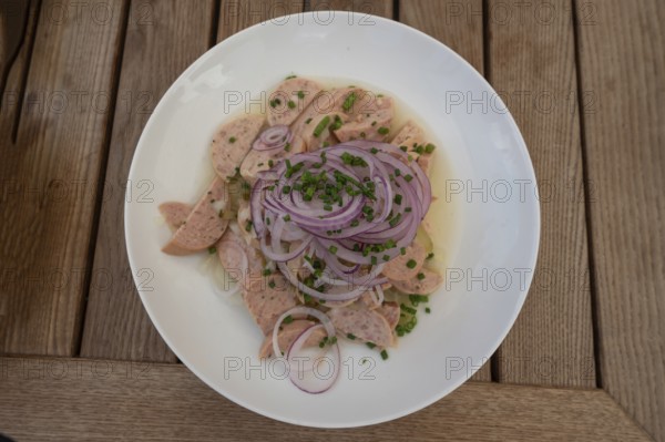City sausage served with onions in a garden restaurant, Franconia, Bavaria, Germany