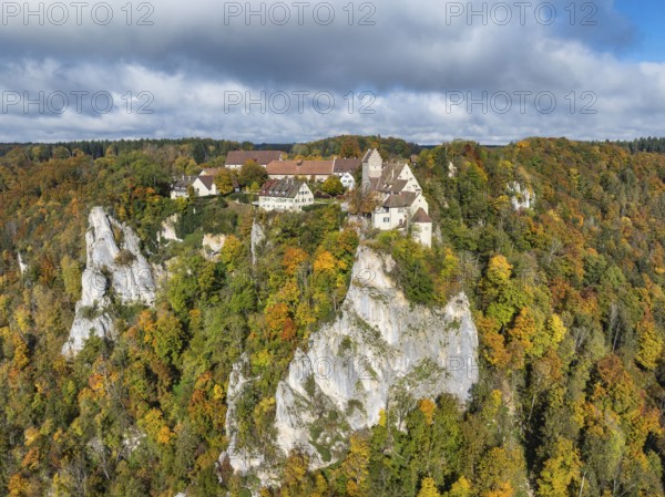 Aerial view of Werenwag Castle and former Werenwag Castle on a rocky spur in the Upper Danube Valley, surrounded by autumnal vegetation and clouds of fog, Sigmaringen district, Baden-Württemberg, Germany