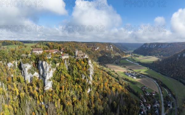 Aerial view, panorama of Werenwag castle and former castle on a rocky spur in the upper Danube Valley, surrounded by autumnal vegetation and clouds of fog, Sigmaringen district, Baden-Württemberg, Germany