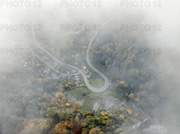 Aerial view of the viewpoint, shovels and Hausen Castle, also known as the Hausen ruins, surrounded by autumnal vegetation and clouds of fog on the village of Hausen in the valley in the Upper Danube Valley, Beuron, Sigmaringen district, Baden-Württemberg, Germany