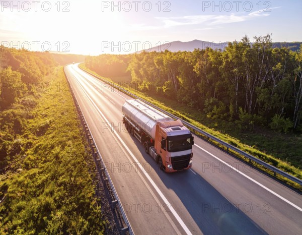 Petrol cargo truck lorry tanker driving on highway hauling oil products at sunrise, wide hilly landscape, AI generated