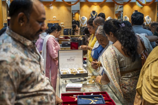 Customers purchase Gold jewelry at a store on the occasion of the festival of Dhanteras, in Guwahati, Assam, India on 18 October 2025. People rushing to buy gold even after its nearly 60% surge to record highs this year