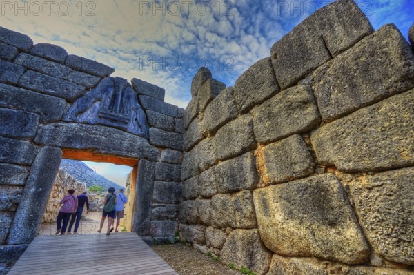 HDR, group of visitors passes through a huge stone gate, lion gate, Mycenae, archaeological site, UNESCO World Heritage Site, Mycenae, Mycenae, important city in pre-classical times, Peloponnese, peninsula, Greece